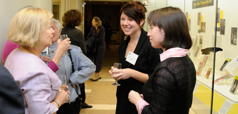 photo of women chatting in the Coombe Suite gallery Alumnae and students chat at the opening of the Coombe Suite